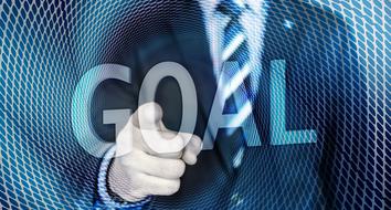 Businessman pointing at word goal