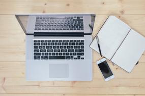 gray laptop on wooden table