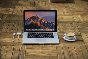 laptop and cup of coffee on the floor