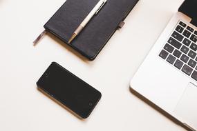 laptop Computer, notebook and phone on Desk