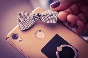 decorative bow with stones on the phone case