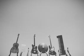 Music Instruments in hands at sky