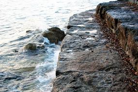 weathered wet stone steps at water