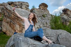 happy Girl taking selfie with Phone on rock