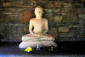 sculpture near a stone wall in sri lanka