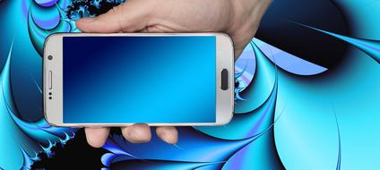 smartphone with a blue screen in a man's hand on a background with patterns