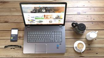 Laptop, phone and Coffee on wooden table