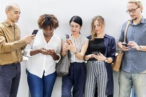 African American Asian people with phone