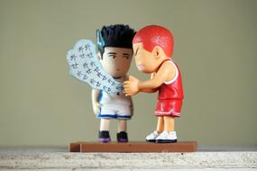 asian and caucasian sportsmen, two funny toy figurines