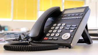 black phone is on the office desk