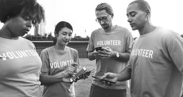 people of different races with telephones in t-shirts in black and white