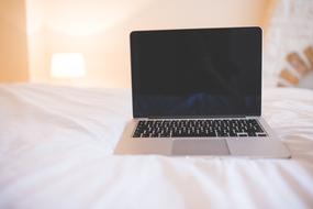 modern laptop on the bed