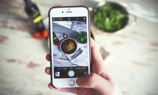 person taking photo of food with Cellphone