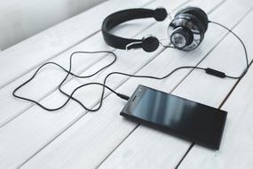 Smartphone and headphones on table