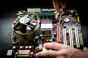Repair of Computer, male hands at board