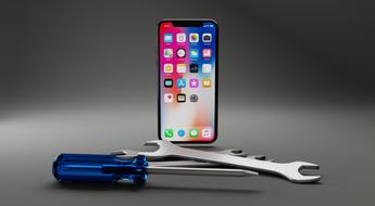 Iphone X and equipment, tools on the surface