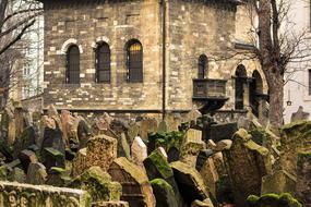 old tombstones in front of a gothic monastery