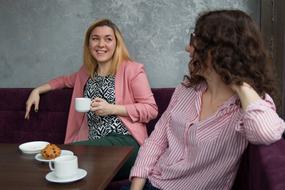 girlfriends drink coffee at the table