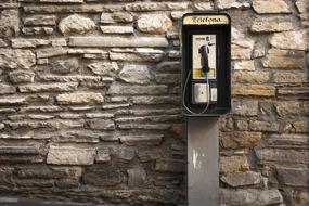 old telephone on a stone wall