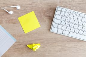 white keyboard and yellow note