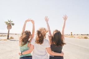 three happy Girlfriends in Desert