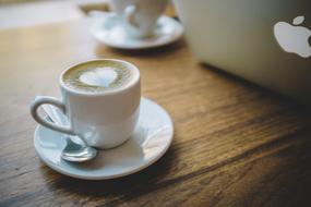 Beautiful drawn heart on the espresso on the wooden table