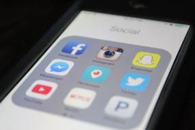 nine social media icons on screen of gadget