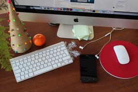 Computer and christmas decorations on Desk in Office