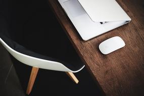 white laptop and white computer mouse on the table