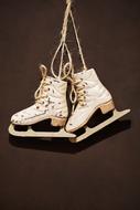 white retro skates hang on the wall