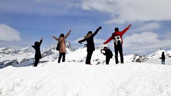 young people posing on Alps Tops at Winter