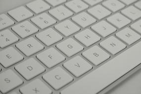 white keyboard with grey letters of a modern computer