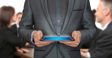 tablet with a blue screen in hand