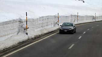 black car driving on the road in winter