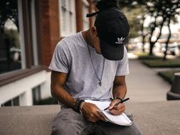 Guy writes on the street