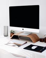 mouse with keyboard and speakers near the computer on the table