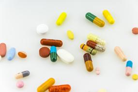 variety of capsules with medicines on white
