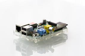 Colorful Raspberry Pi microchip, on the white surface, with reflection