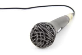 Grey microphone with wire on the white surface