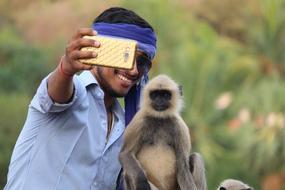 young Boy taking Selfie With Monkey