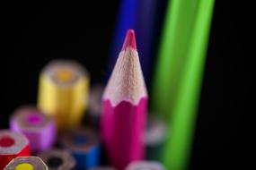 pink pencil on the background of a set of pencils, close-up