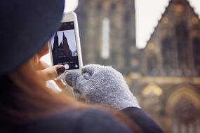 Woman with hat taking beautiful photo of the catherdral in Prague, Czech Republic