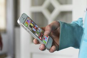 white Iphone in male hand