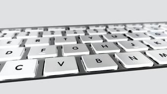 Close-up of the white keyboard with black letters and numbers, in light