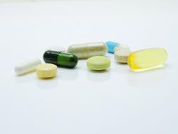 multicolored pills and dietary supplements on the table