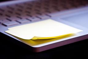 yellow sticky note on laptop