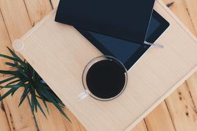 coffee cup, tablet and diary on the coffee table