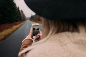 girl with iphone on Road Path