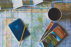 notepad and coffee cup on Colorado map