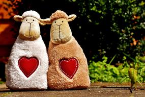 plush sheep with hearts on the street